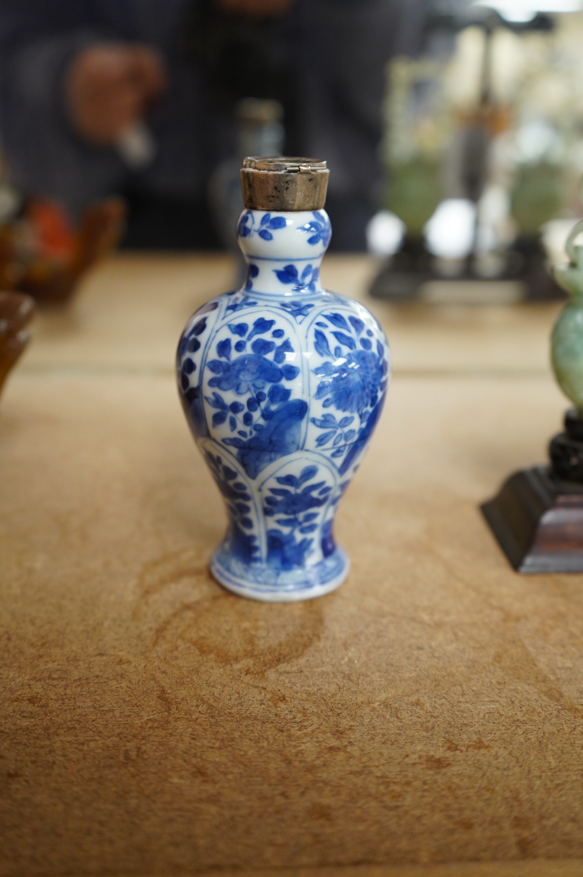 A Chinese small blue and white, white metal mounted vase, Kangxi, 12cm. Condition - poor to fair